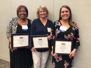 Three women receiving homeward awards