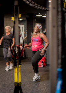 Karen Stanley (left) working out alongside female participants in the Stacey Dendy Fitness Center.